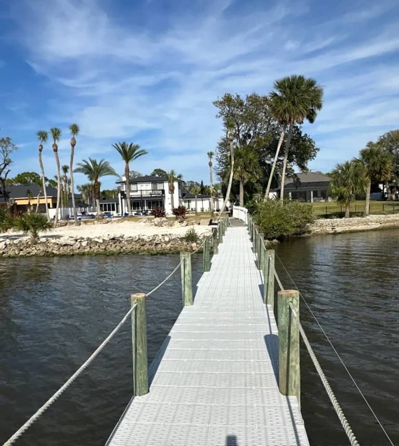Waterfront walkway leading to dock in Florida