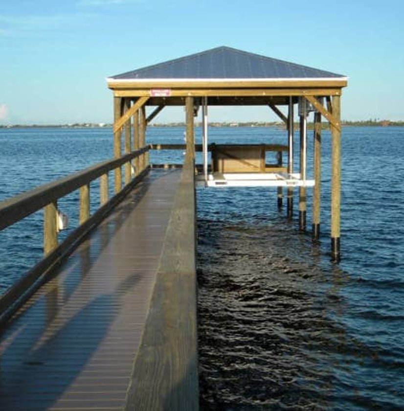 Covered dock extending over clear water
