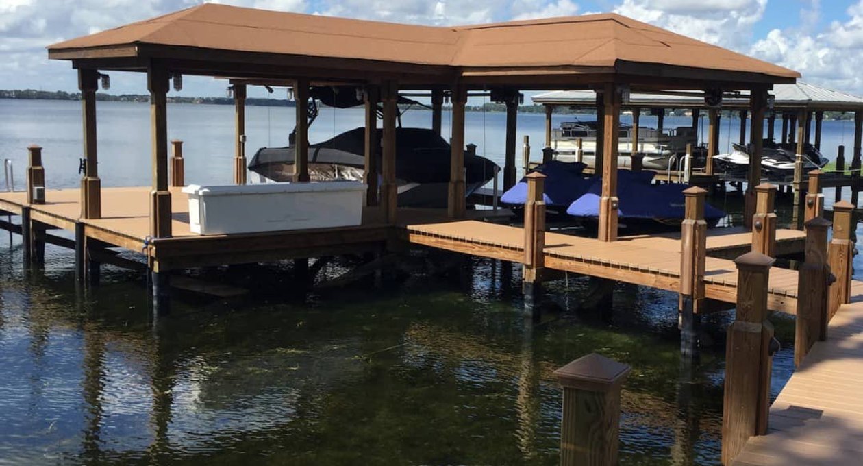 Covered marina dock with boat slips